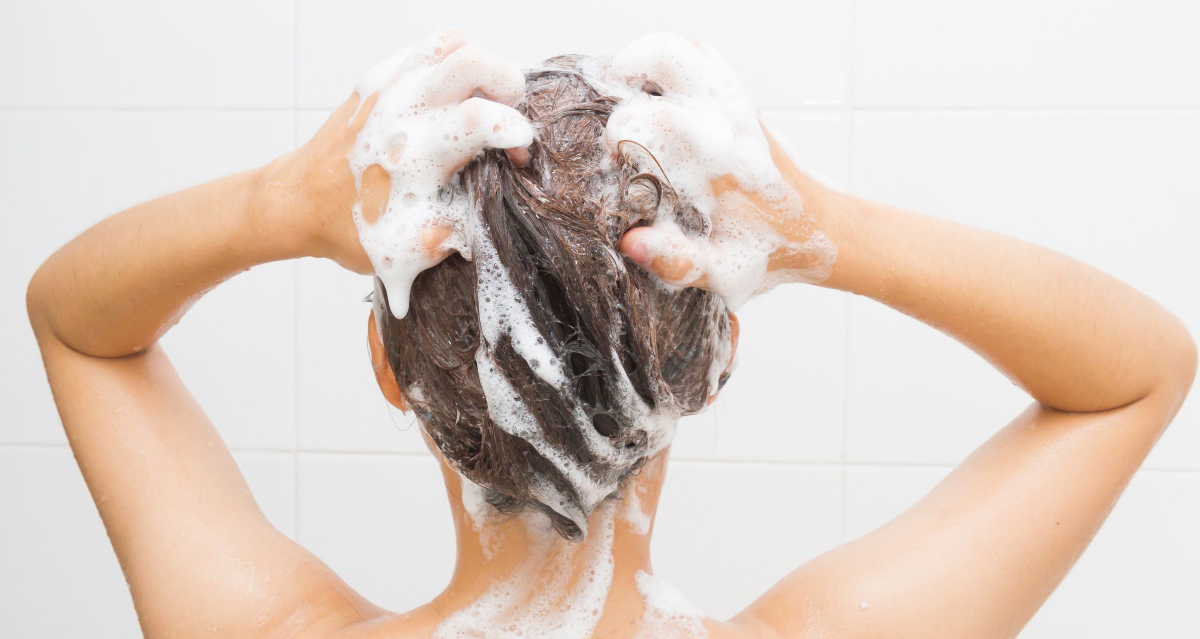 Woman shampooing hair